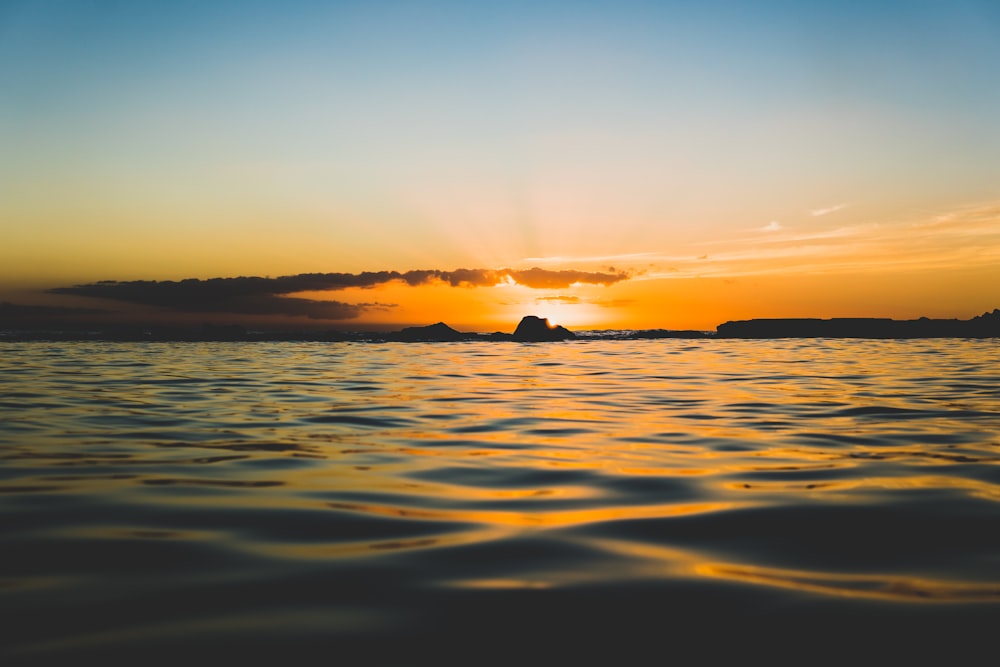 silhouette photo of sea during golden hours