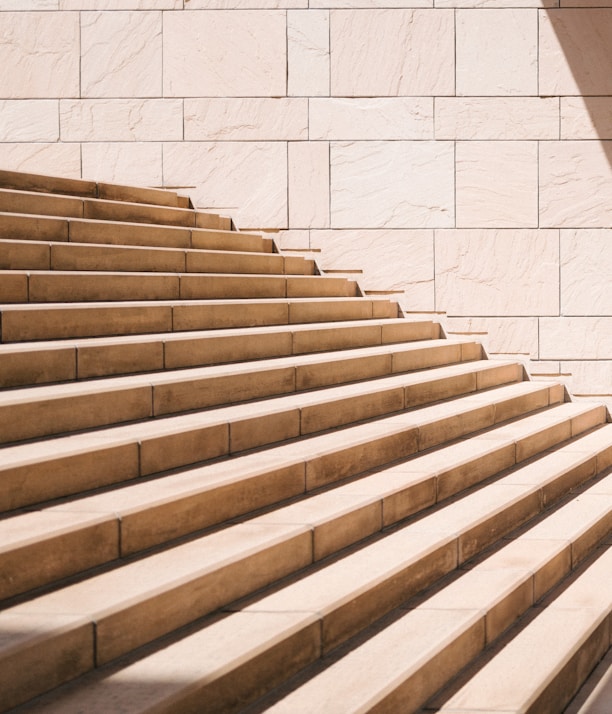 toddler's standing in front of beige concrete stair