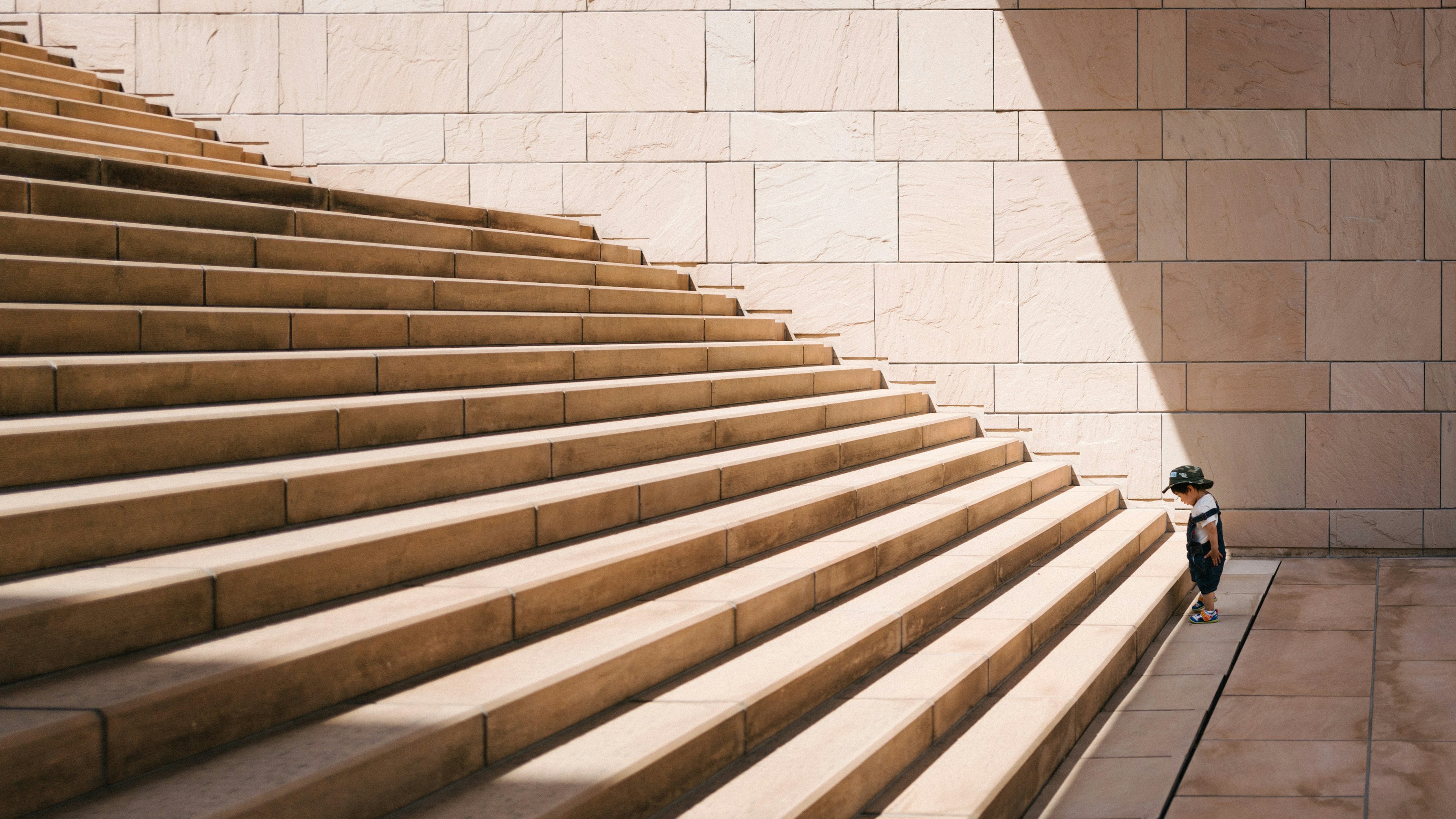 A small child starting up a set of steps.