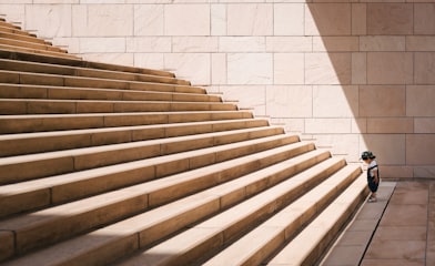 toddler's standing in front of beige concrete stair