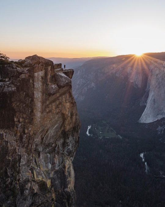 person standing on brown hill during sunset in Yosemite National Park United States