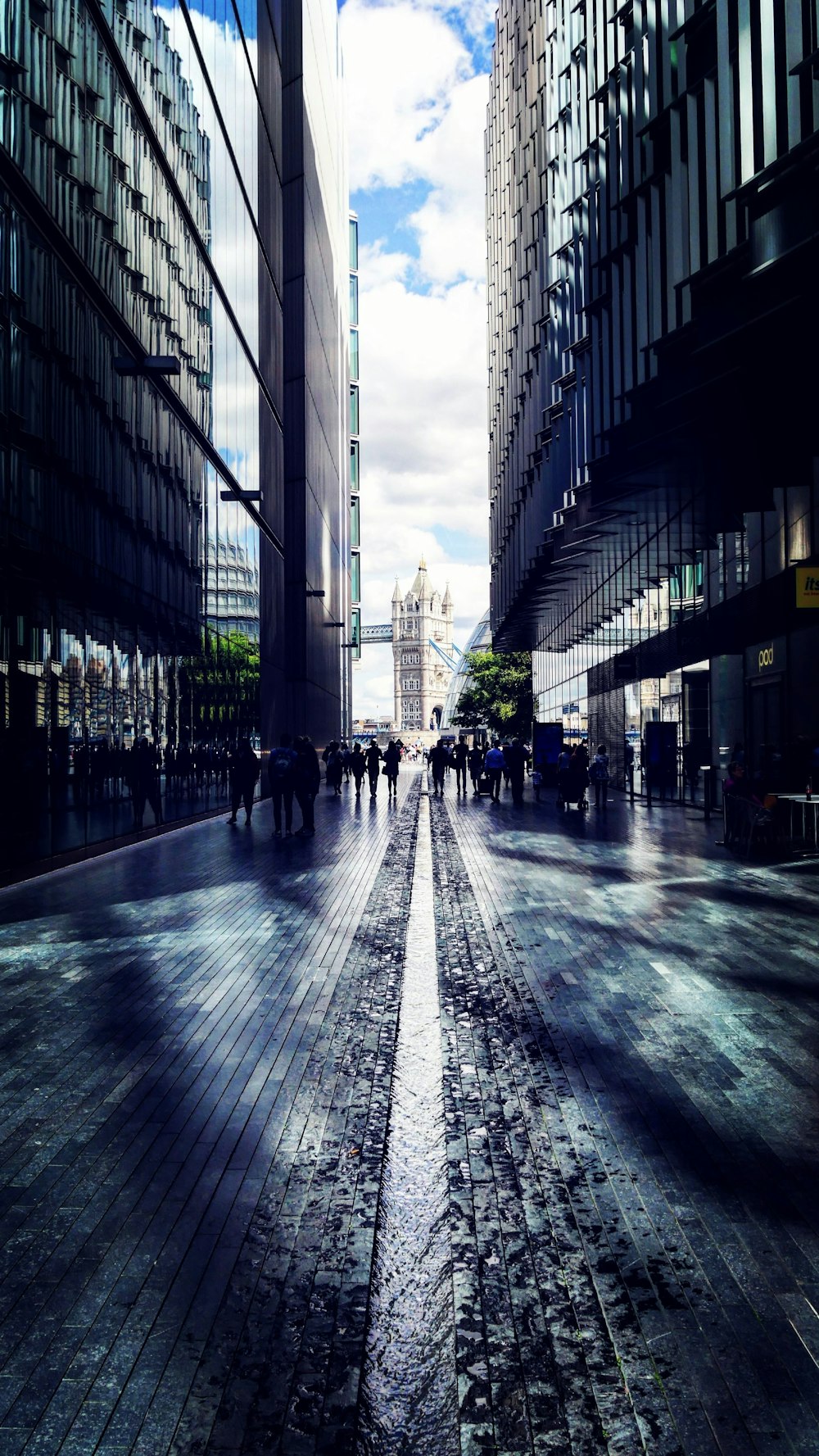 photography of group of people on street walk surrounded by commercial buildings during daytime