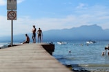 A group of anglers enjoying a sunny day by the lake.