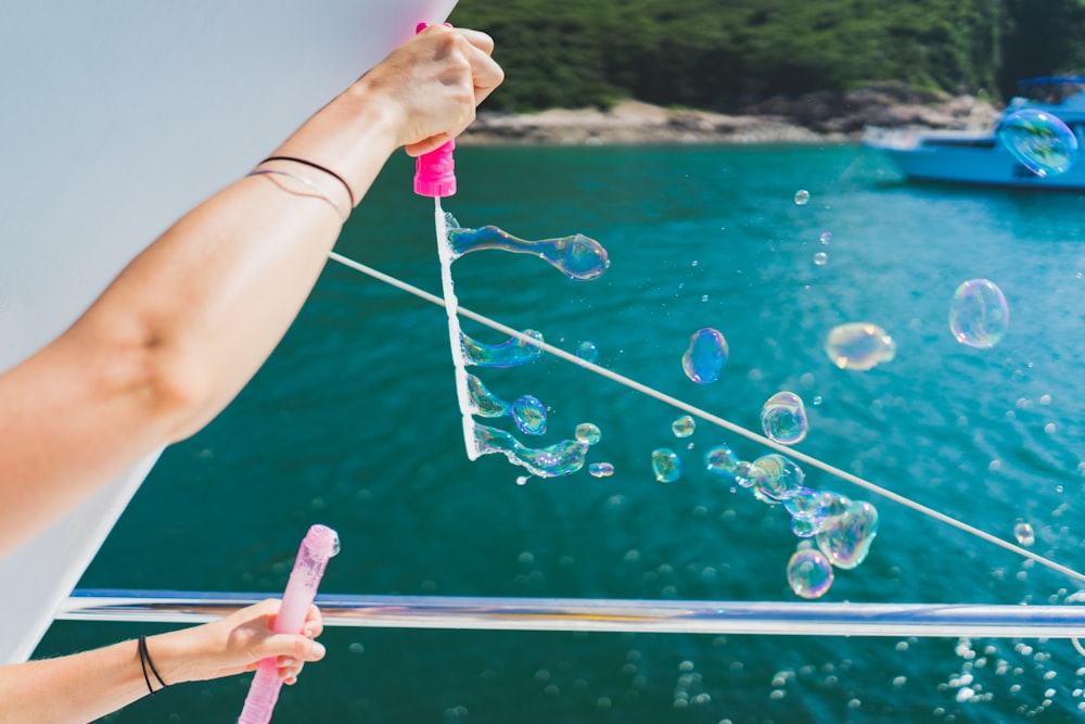 person playing with bubbles during daytime