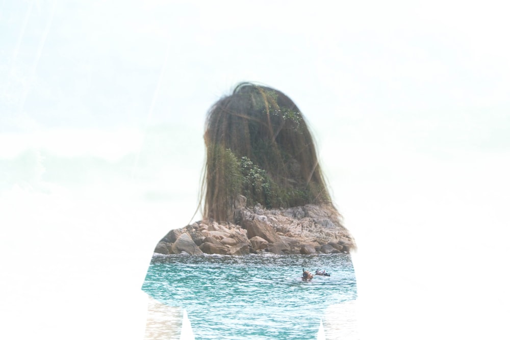 a woman standing in the water with her back to the camera