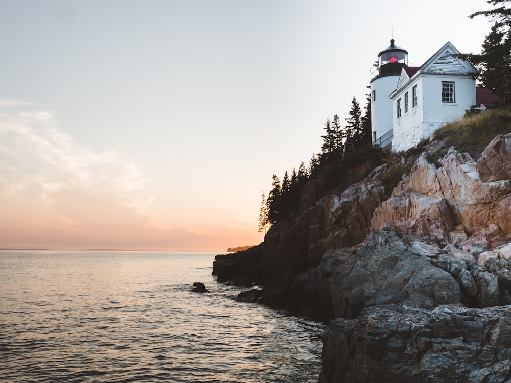 white lighthouse near sea at daytime