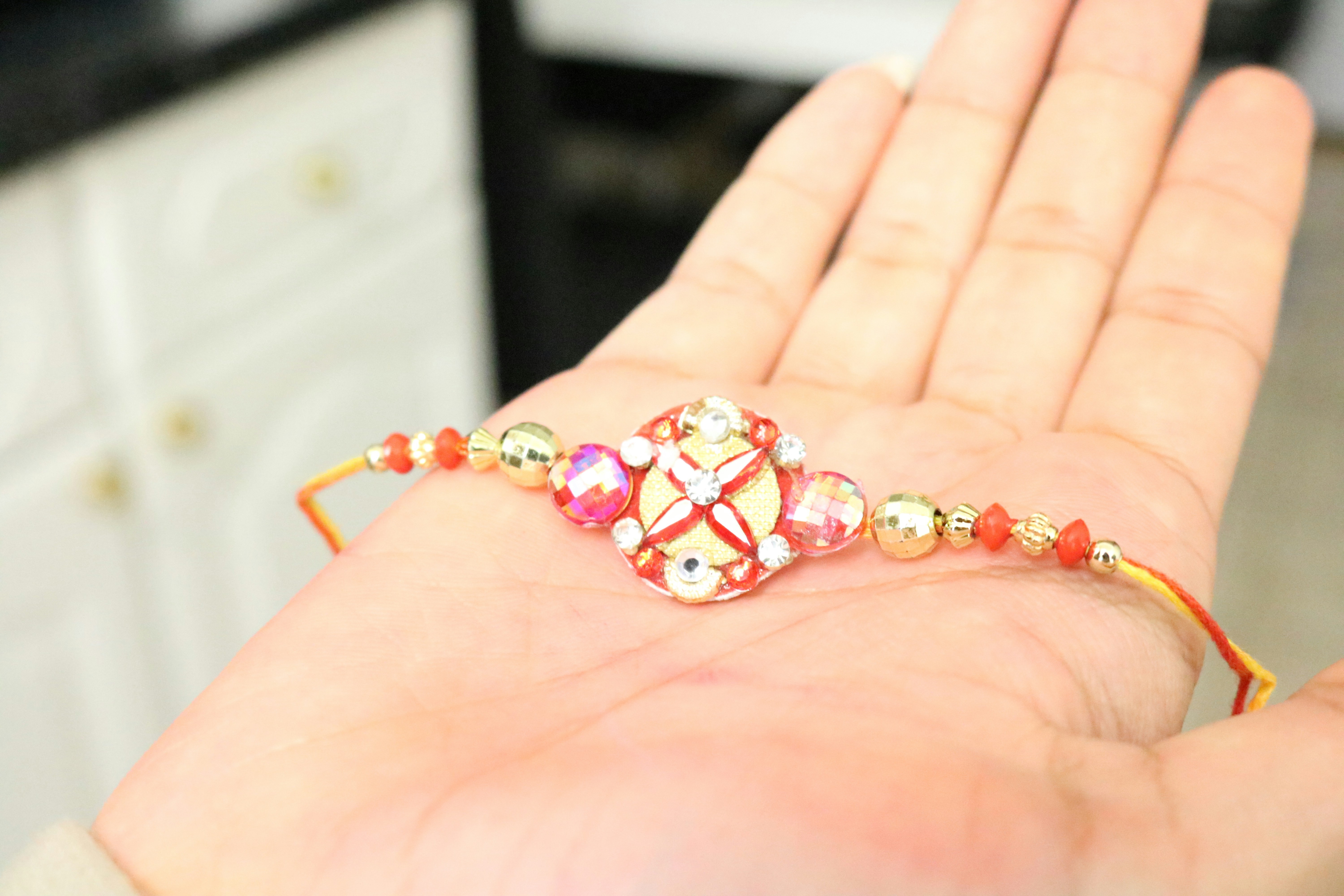 Silver rakhis - handcrafted silver rakhi with bee and floral motifs