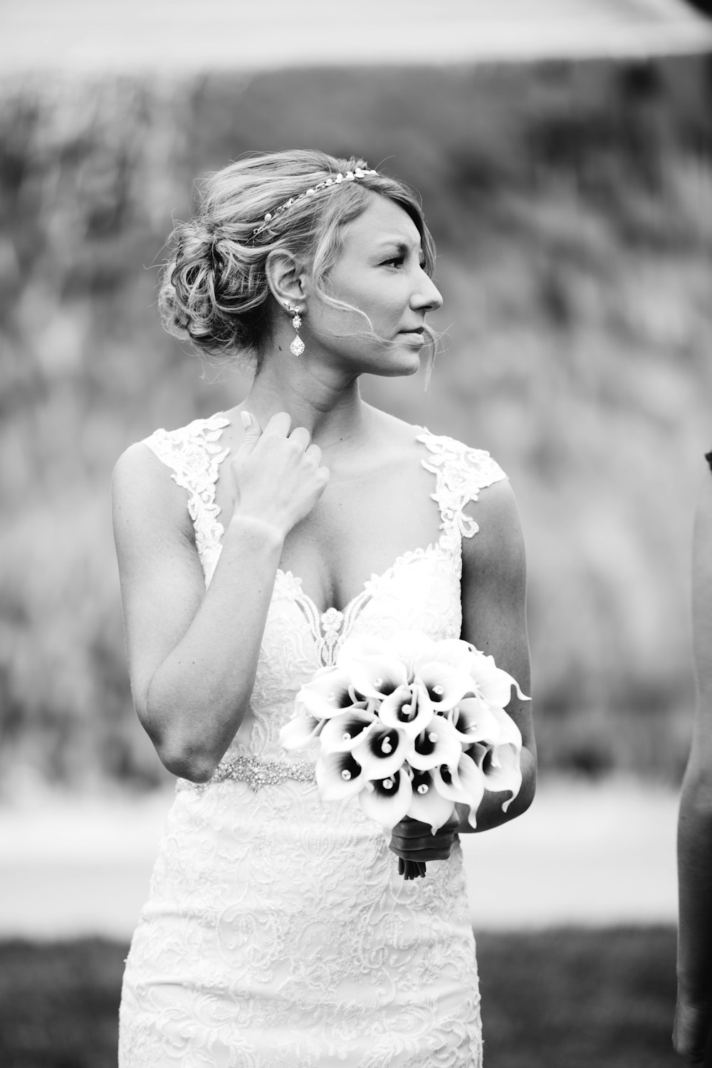 greyscale photography of woman holding bouquet