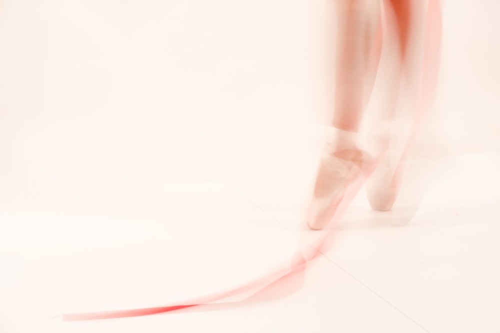 a blurry photo of a woman's legs and shoes