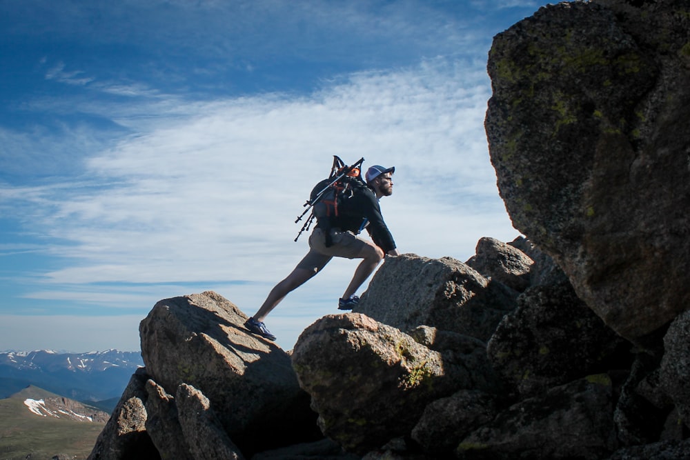 photo of man climbing mountain