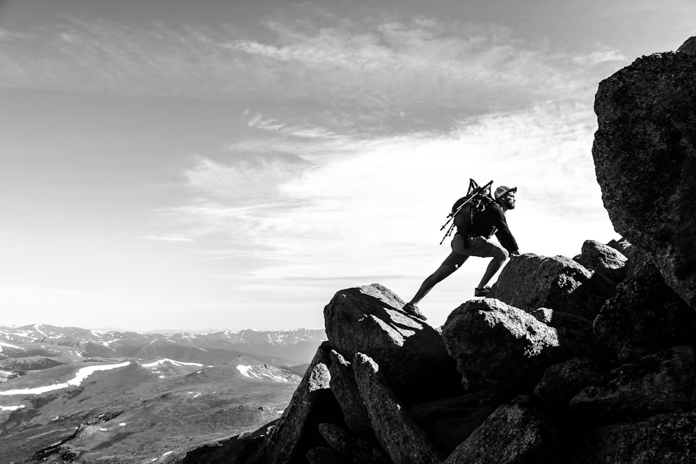 man rock climbing on mountain