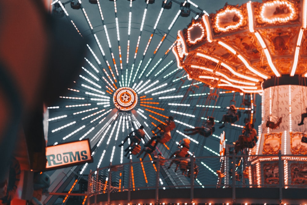 people riding on ferris wheel at night