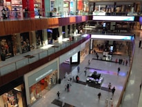 Completed commercial mall shining under the sun with people walking around in Punjab.