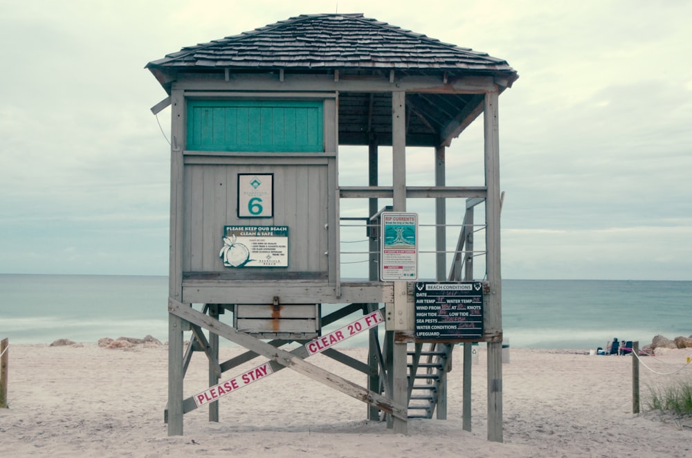 empty brown and green wooden lifeguard house