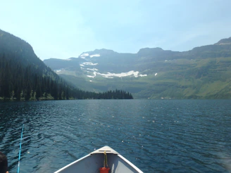 A serene Swedish lake surrounded by pine trees with a small boat ready for bass fishing.