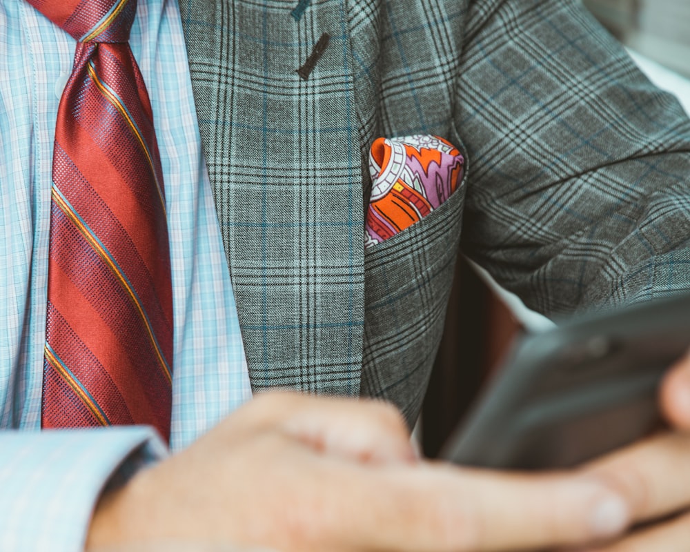 selective focus photography of person holding black smartphone