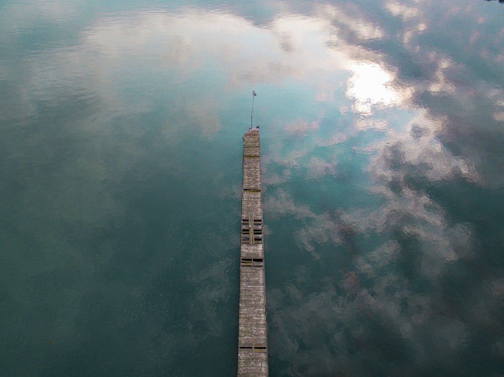 brown wooden dock on body of water