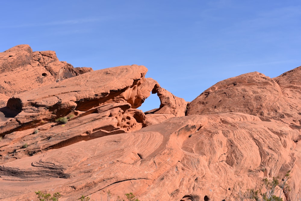 brown rock formation under blue sky