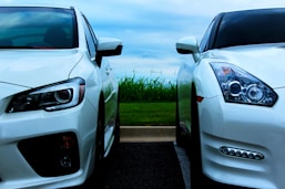 white Nissan GT-R and white Mitsubishi Lancer Evolution 10