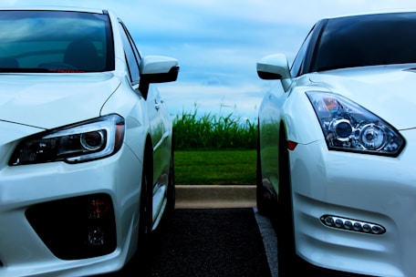 white Nissan GT-R and white Mitsubishi Lancer Evolution 10