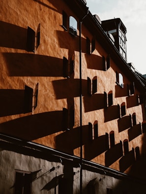 A stylish exterior facade painted in warm white with subtle gold highlights under natural light.