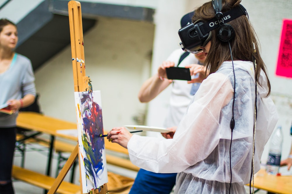 woman doing painting during daytime