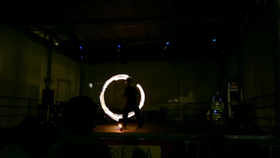 Marco Marzico performing a captivating close-up magic trick on stage with dramatic lighting.