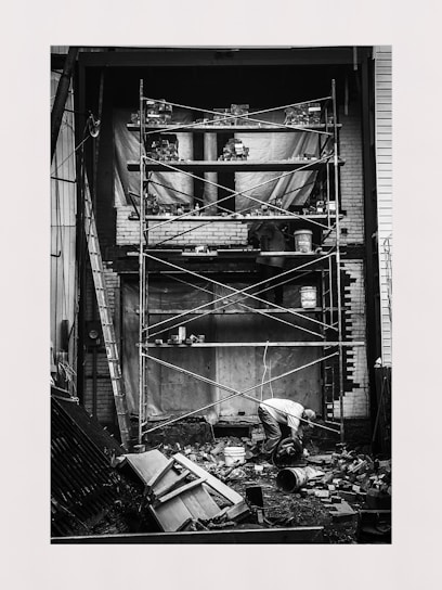 Photo of skilled artisans working on a building site with masonry and carpentry tools.