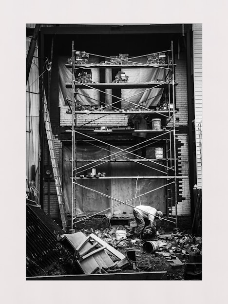 Photo of a skilled builder working on a residential construction site, carefully laying bricks.