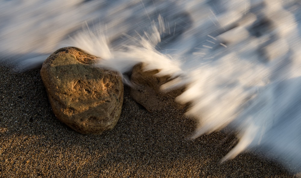 timelapse photo of sea water and brown stone