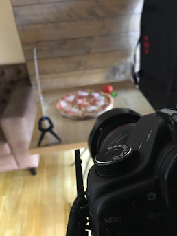 Behind-the-scenes shot of the Pomodoro team photographing fresh produce and plating dishes.