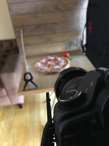 Behind-the-scenes shot of the Pomodoro team planning social media content around a wooden table.