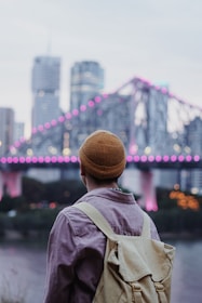 selective focus photography of man carrying bag
