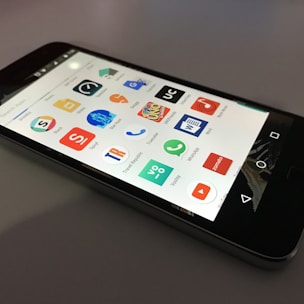 black Android smartphone lying on gray surface