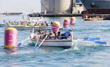 Swimmers boarding a boat for the 2k race start with the iconic arch in the background