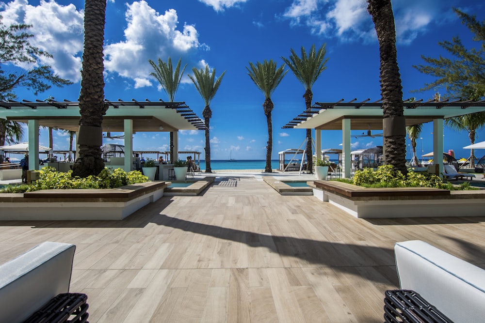 landscape photography of two pergolas near body of water