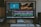 A computer monitor displays video editing software with multiple tracks of video and audio clips in a timeline. An image of aquatic life and another of a turtle are shown on the upper part of the screen. The workspace includes a keyboard, mouse, and external hard drive situated on the desk.