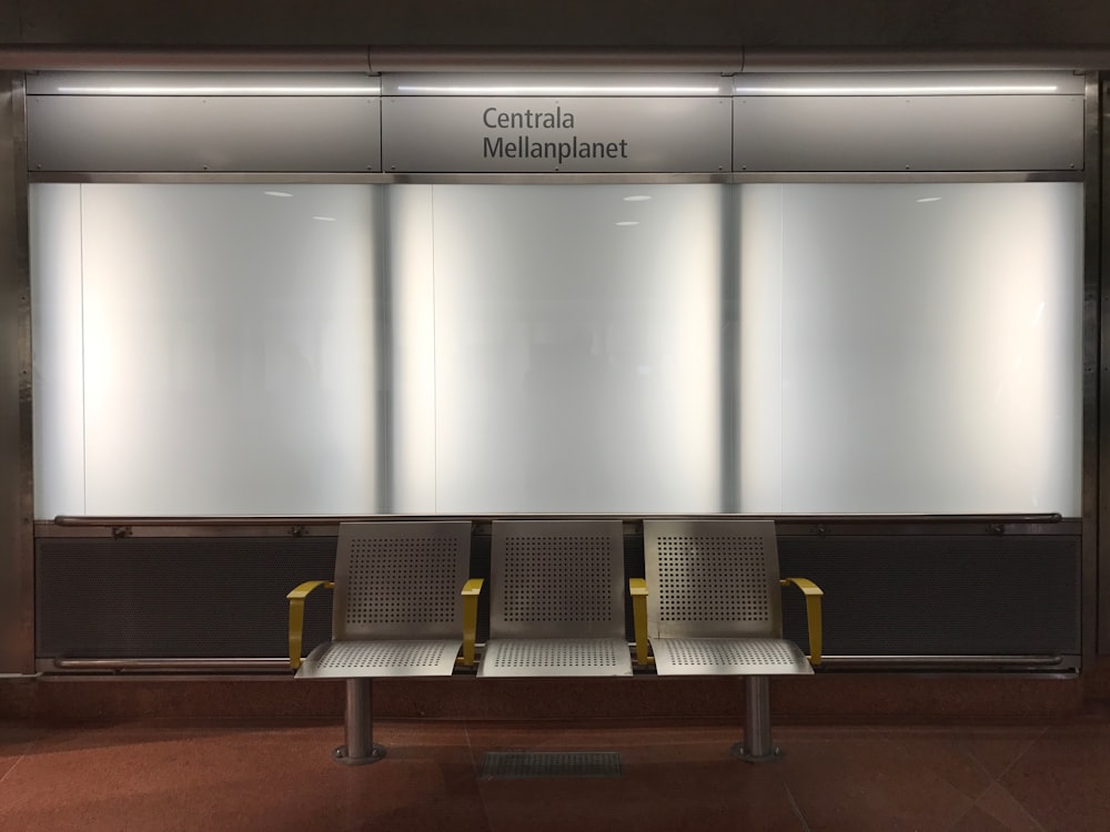 3-seat chair in front of lighted bulletin boards