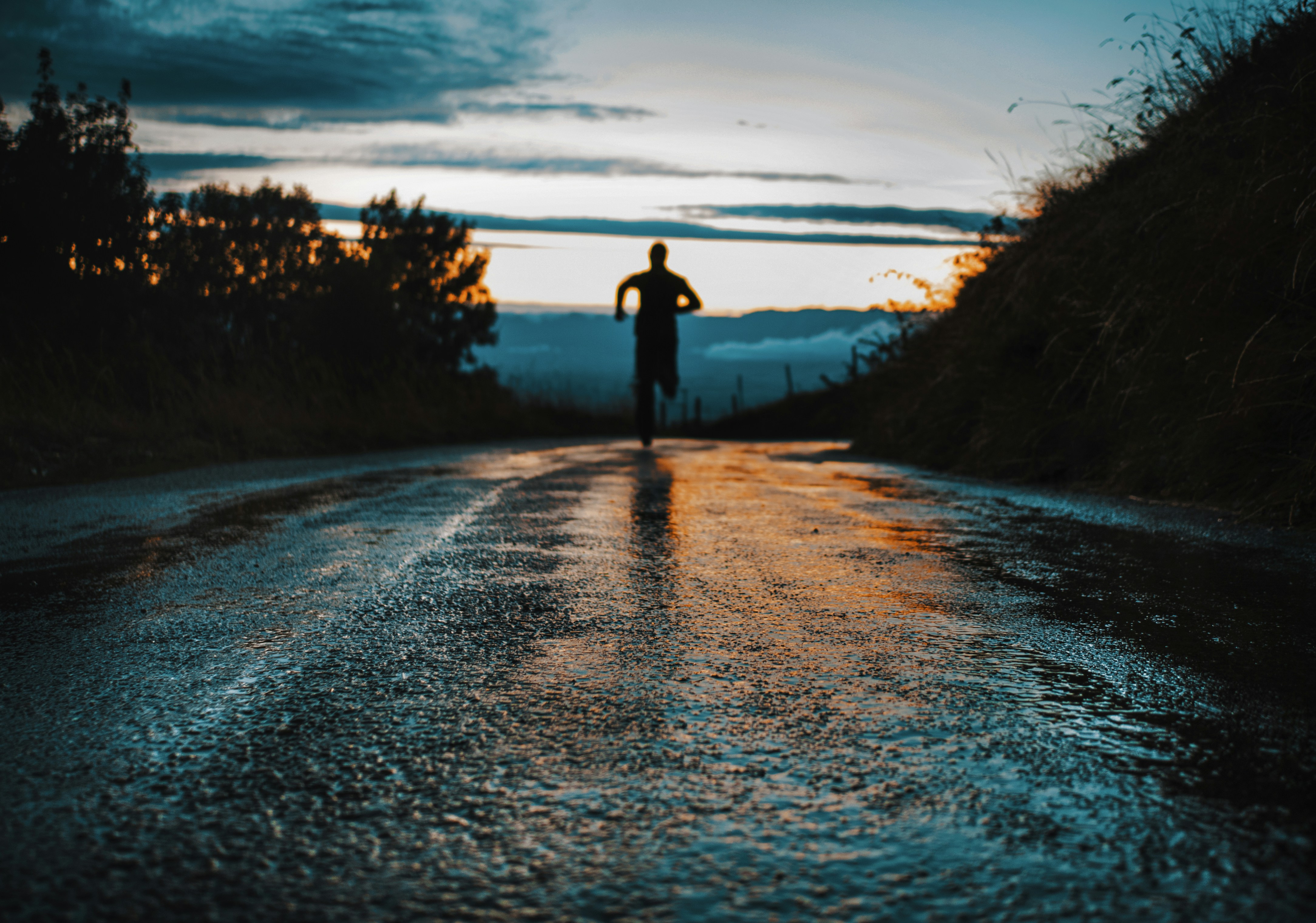 silhouette of a person running on road