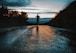silhouette photo of a person running on road