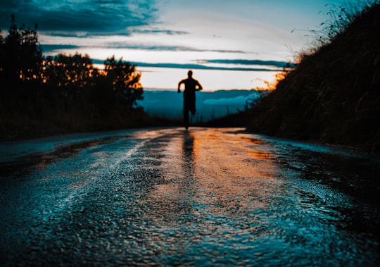 silhouette photo of a person running on road in Salève France