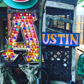 An outdoor Austin Legal Crew booth set up at a sunny local festival, welcoming visitors.