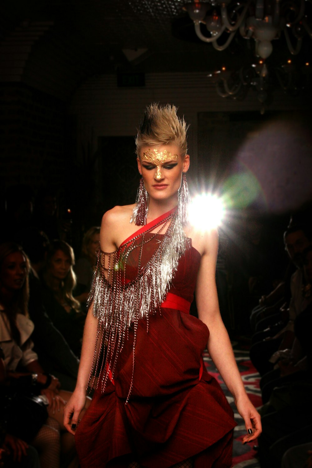 woman in red strapless dress surrounded by people