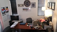 An office setting with a computer and real estate listings.