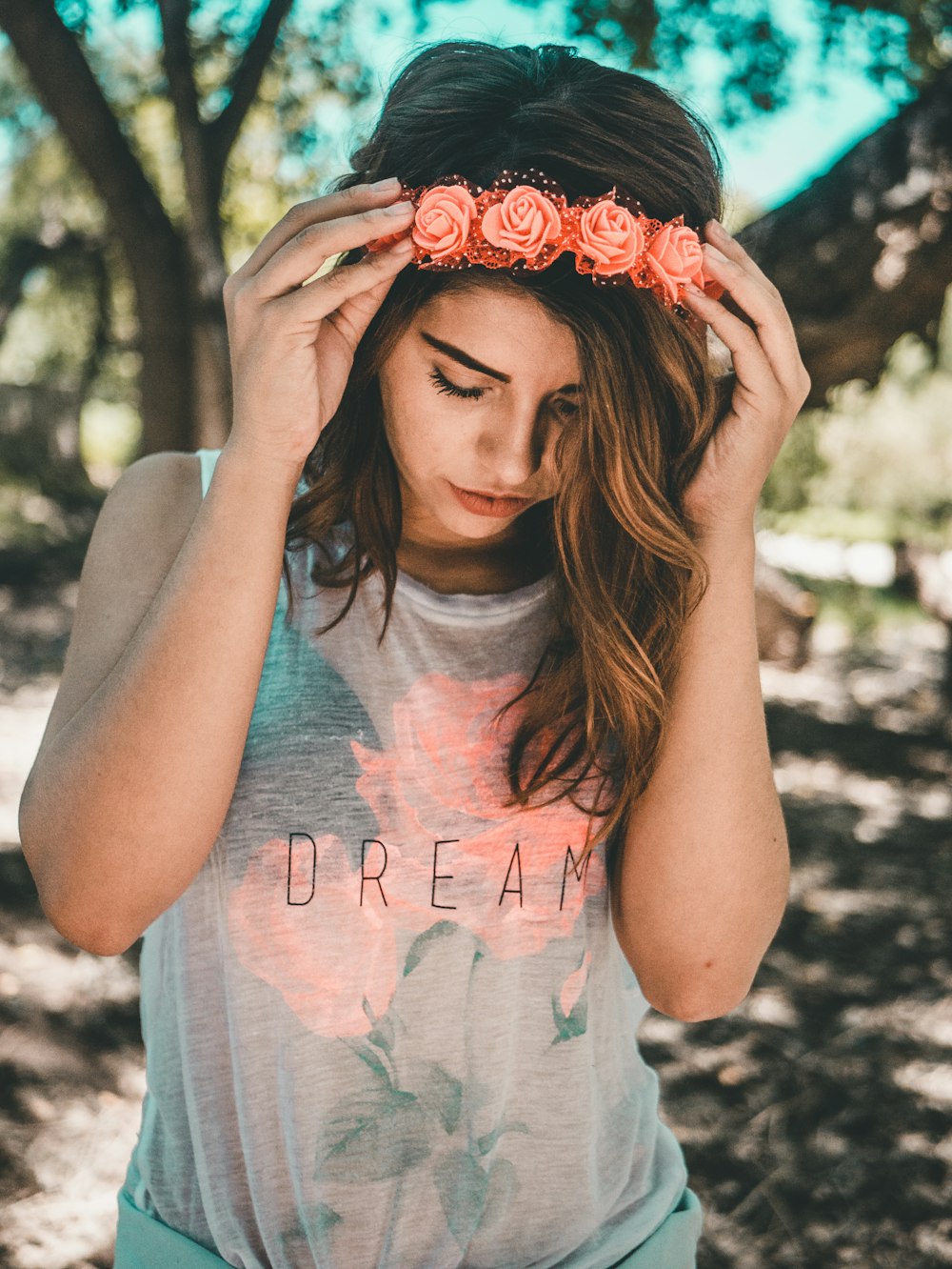 woman in gray and pink floral sleeveless top during daytime