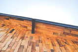 Close-up of a newly installed traditional wooden roof frame in a suburban home.