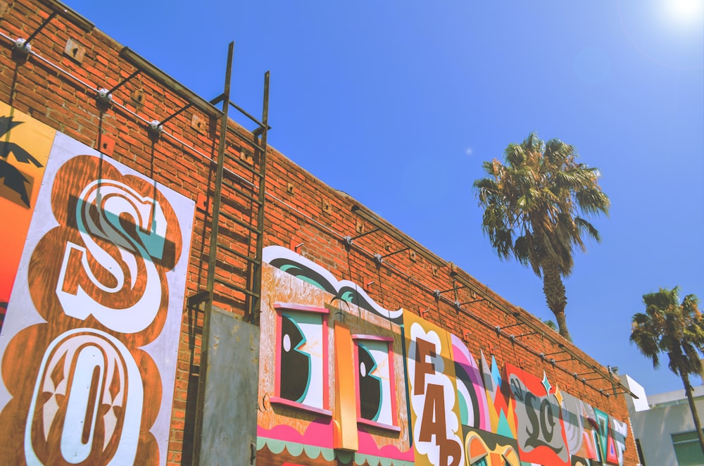 brown concrete wall with graffiti painting