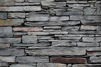 minimalist photography of gray rock wall