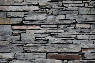 minimalist photography of gray rock wall