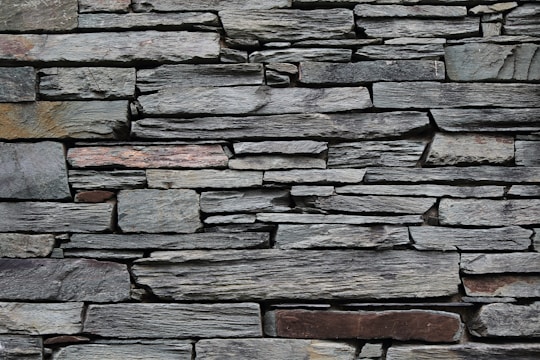 minimalist photography of gray rock wall